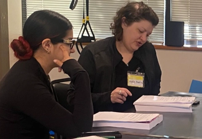 instructor reviewing written material with a student
